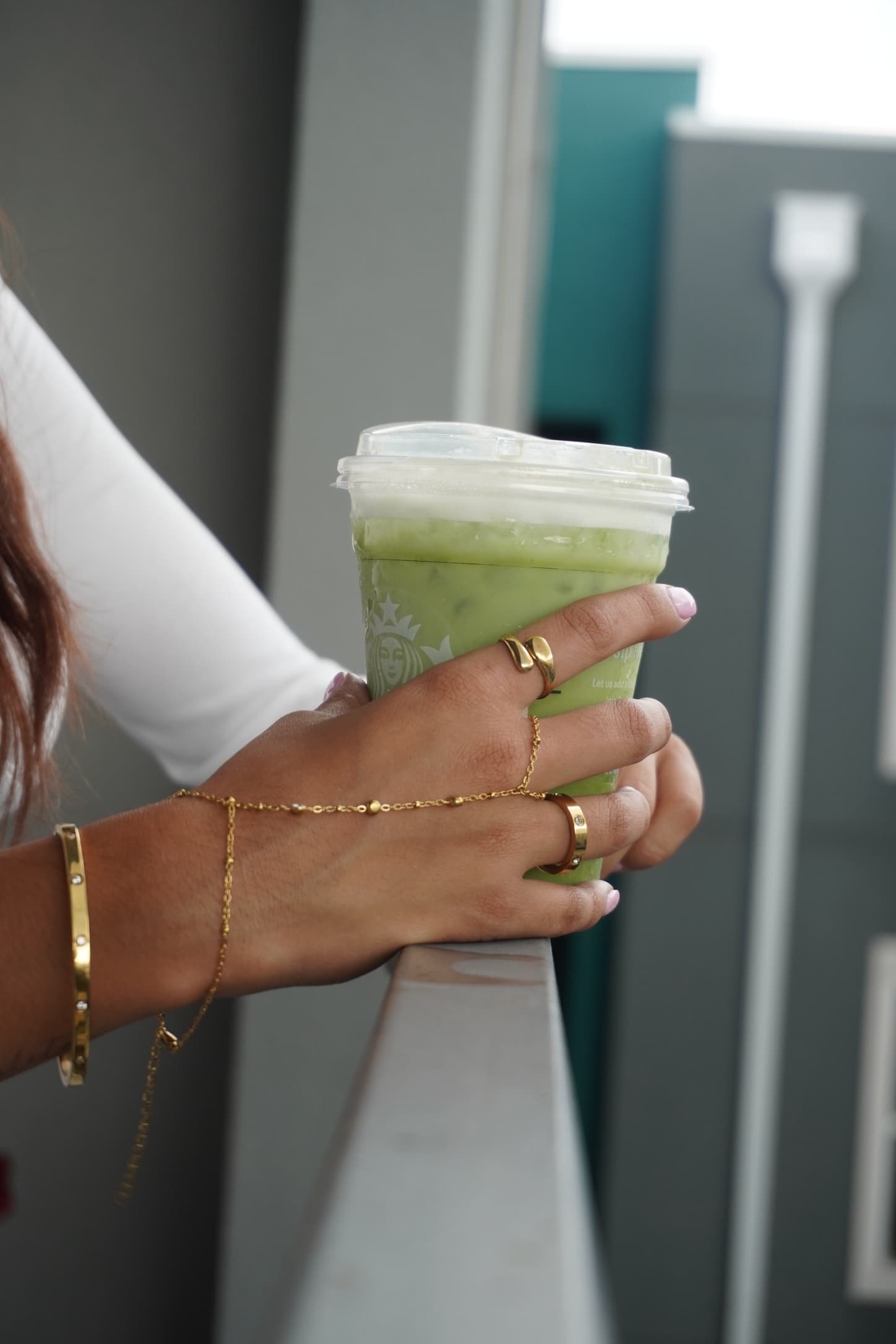 Gold-tone Krystal Jewels necklace, rings and bangles worn with a white top
